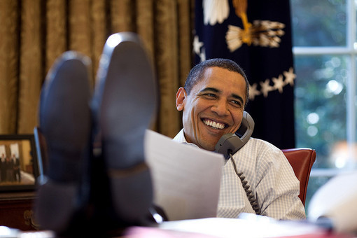 President Barack Obama smiles while talking with Russian President Dmitry Medvedev on the phone in the Oval Office, Saturday, Dec. 12, 2009. (Official White House Photo by Pete Souza)