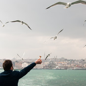 Feeding the seagulls on Bosphorus on a ferry traveling from the European to Asian part of the city of Istanbul @ Istanbul, Turkey, 2013 <em>Photo: © Saša Huzjak</em>